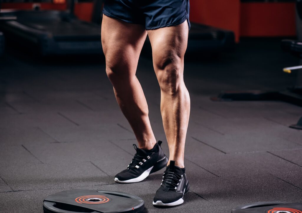 Close up of man's athletic, muscular legs with smooth skin from laser hair removal in NYC