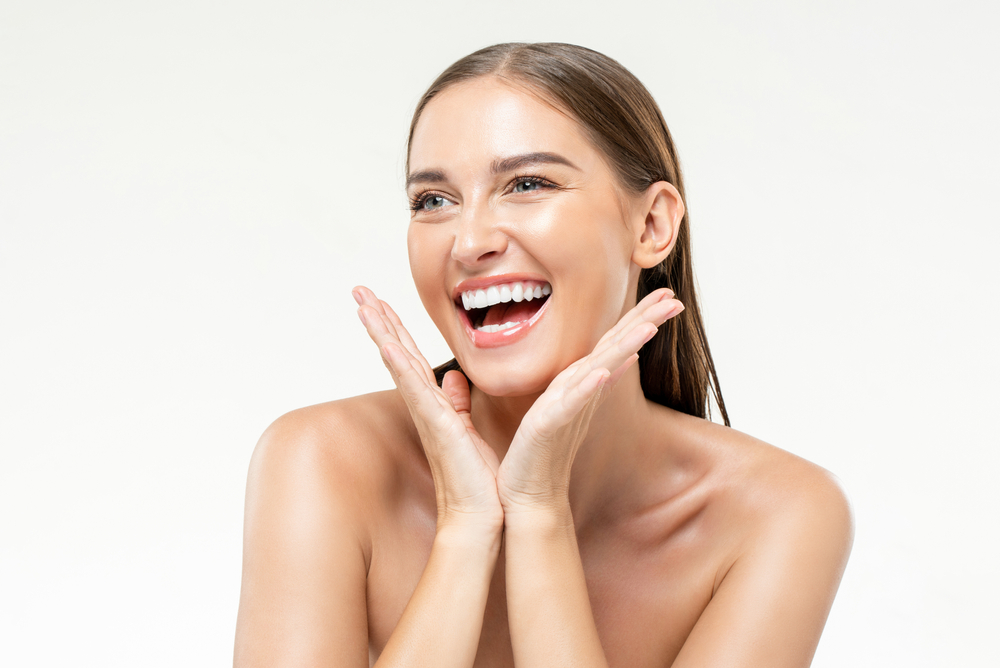 Woman smiling with smooth facial skin from laser hair removal in NYC